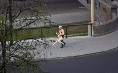 A man carries a rubber woman